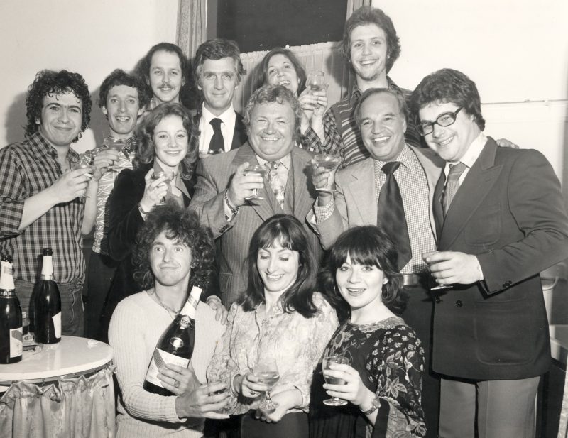 Producers Joseph Beruh and Cameron Mackintosh with the company of Godspell and guests in Dressing Room 1 of Her Majesty's Theatre, London